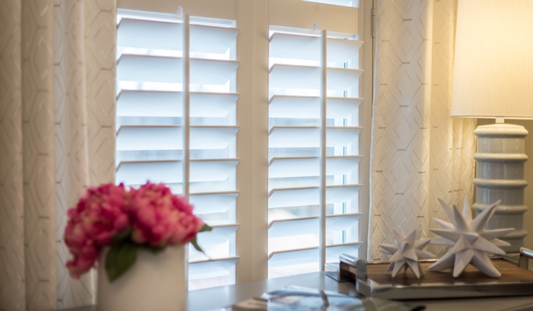 Plantation shutters by flowers in Houston